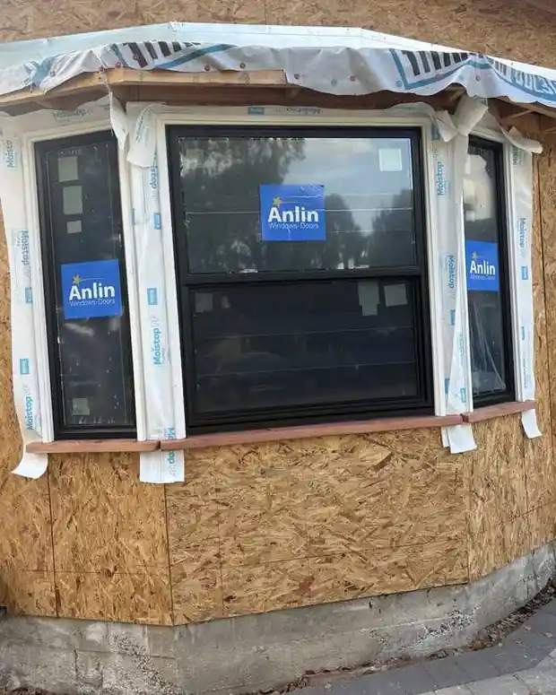 Black bay-style window installation