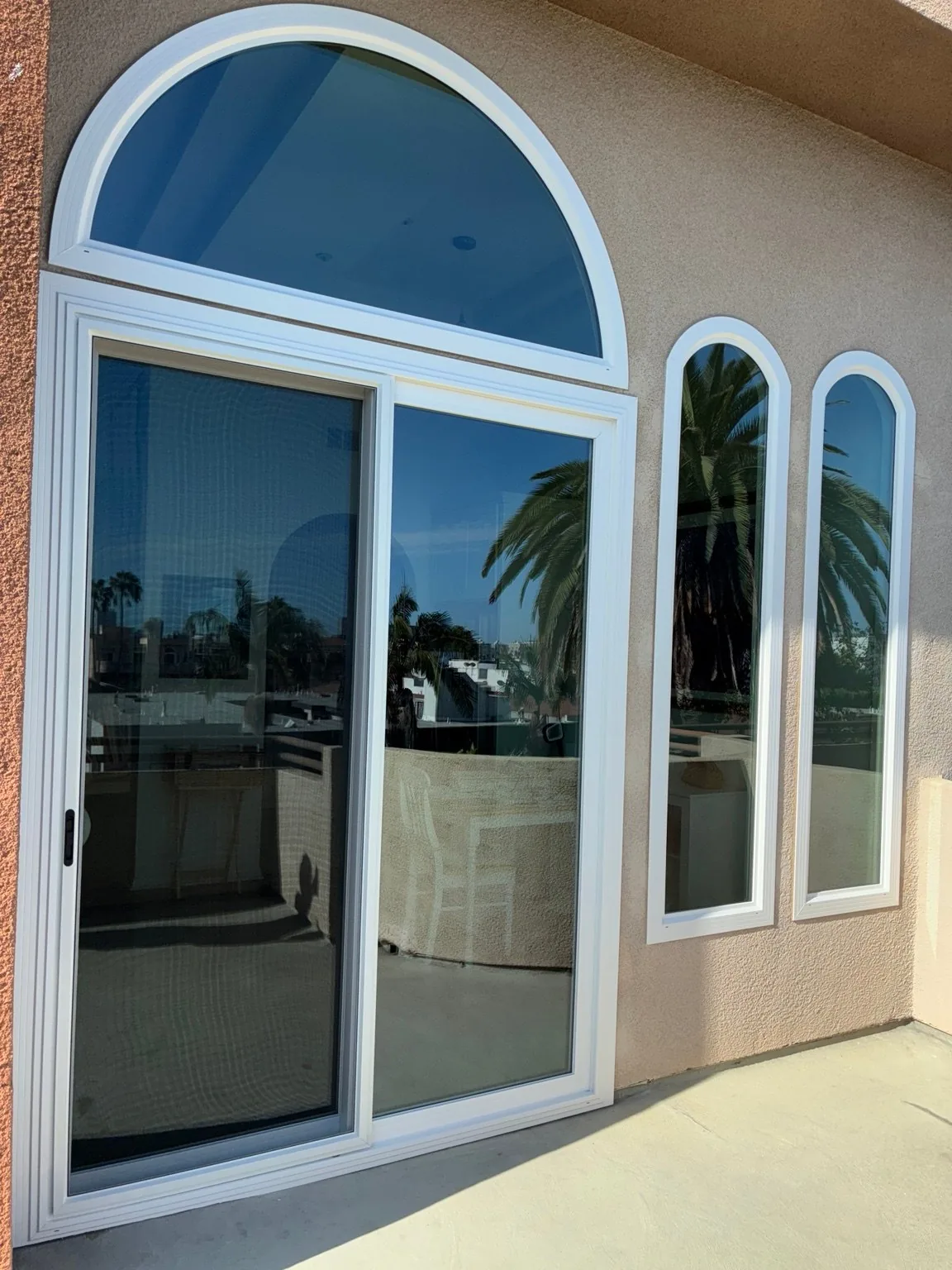 Exterior view of completed arched window and patio door installation
